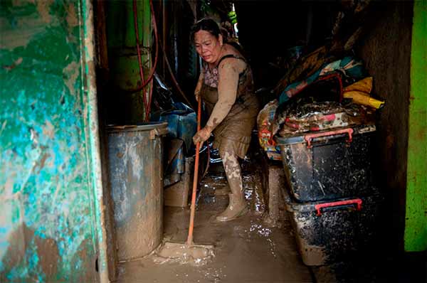 pope assures Filipinos battered by storms floods prayers woman flood storm