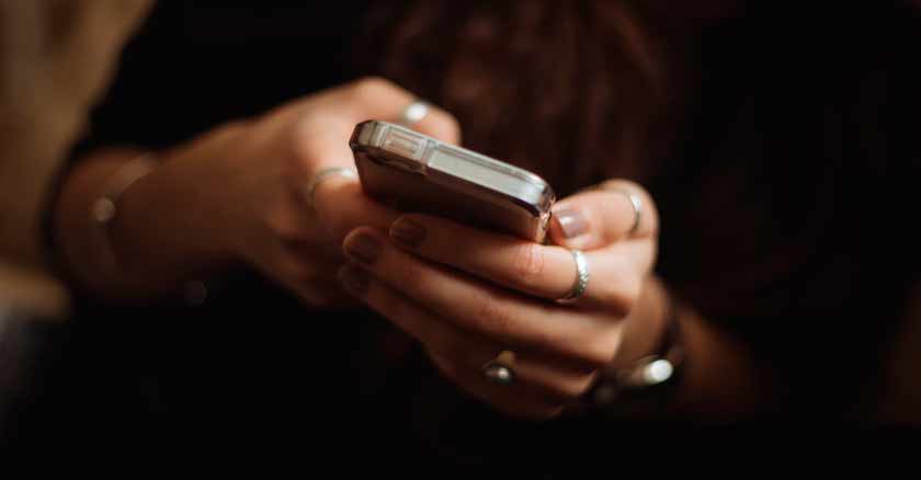 mujer con celular telefonos de emergencias